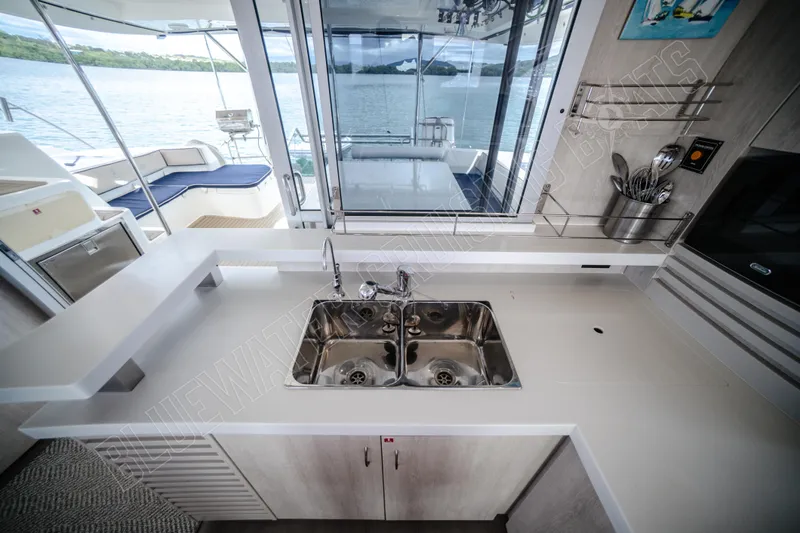 Purple Pearl Yacht Photos Pics Modern kitchen on a 2015 Leopard 48 yacht with dual sinks and outdoor view.