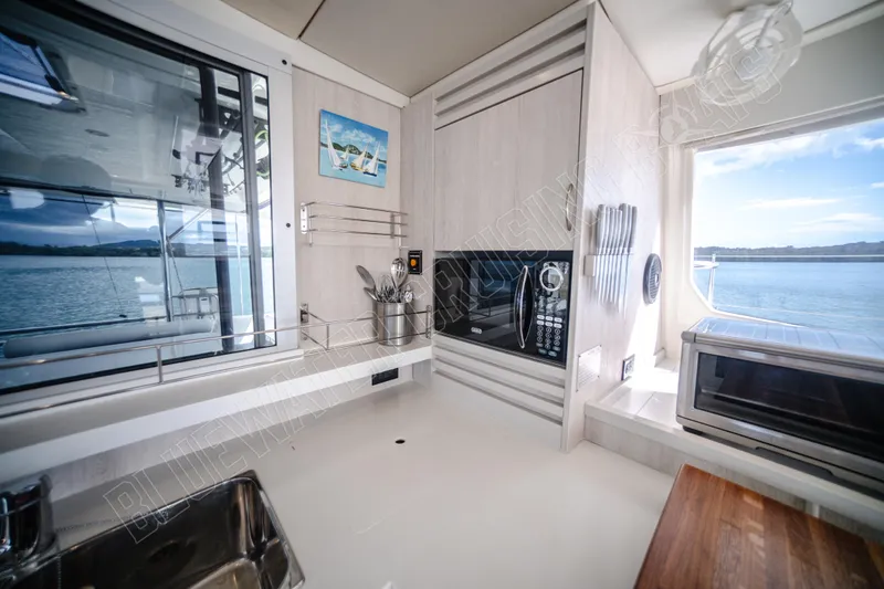 Purple Pearl Yacht Photos Pics Modern kitchen interior on 2015 Leopard 48 yacht with ocean view.