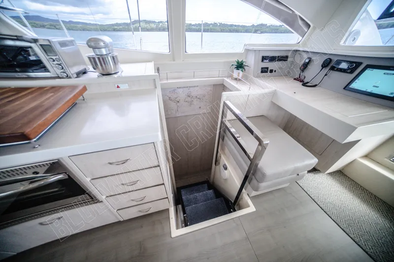 Purple Pearl Yacht Photos Pics Interior of 2015 Leopard 48 yacht with modern kitchen and navigation area.