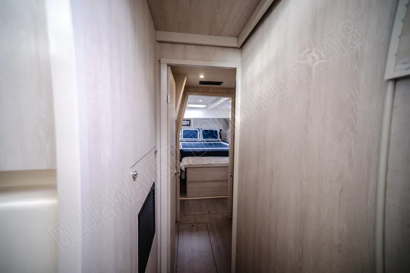 Purple Pearl Yacht Photos Pics Narrow hallway leading to a cozy bedroom in a 2015 Leopard 48 yacht.