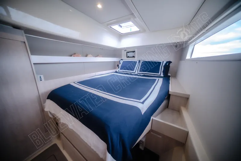 Purple Pearl Yacht Photos Pics Luxurious cabin interior of 2015 Leopard 48 yacht with blue bedding and modern design.