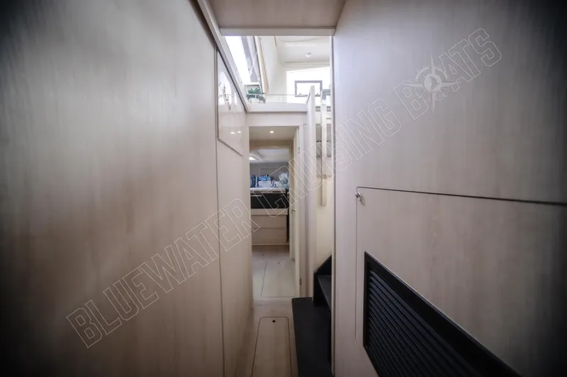 Purple Pearl Yacht Photos Pics Narrow hallway inside 2015 Leopard 48 yacht, featuring modern interior design and natural lighting.