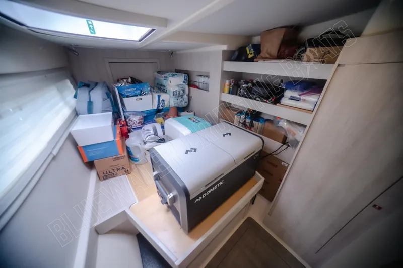 Purple Pearl Yacht Photos Pics Storage area in a 2015 Leopard 48 yacht with supplies and a Dometic cooler.