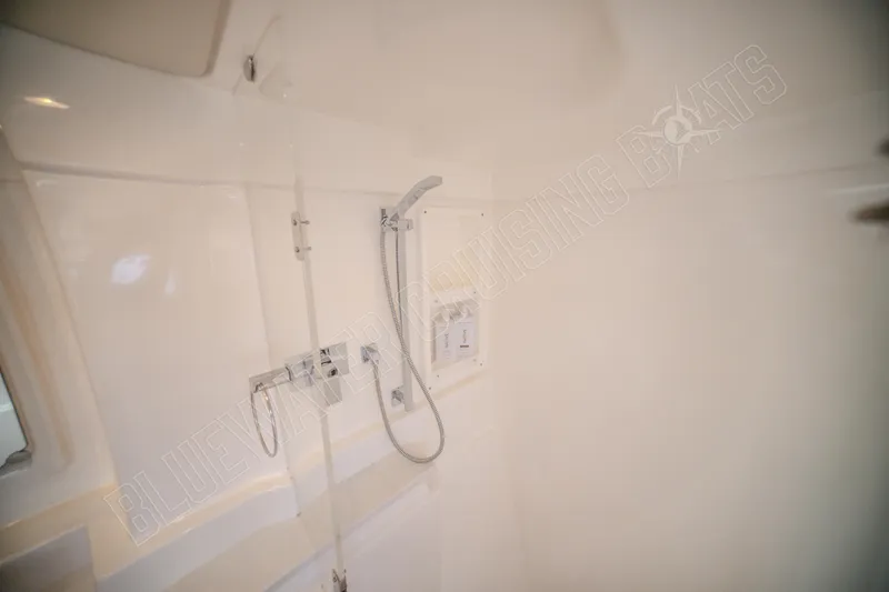 Purple Pearl Yacht Photos Pics Interior of a 2015 Leopard 48 yacht shower area, featuring sleek white design and modern fixtures.