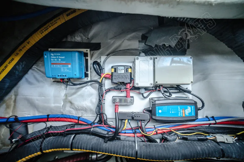 Purple Pearl Yacht Photos Pics Electrical system components in a 2015 Leopard 48 yacht, featuring wiring and chargers.