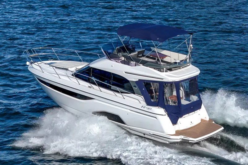  Yacht Photos Pics 2024 Bavaria R40 yacht cruising on open water, showcasing sleek design and luxury features.