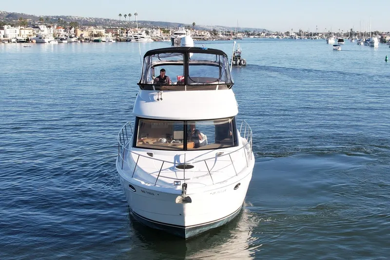Cynisca Yacht Photos Pics 2006 Meridian 391 Sedan yacht cruising in a scenic harbor setting.