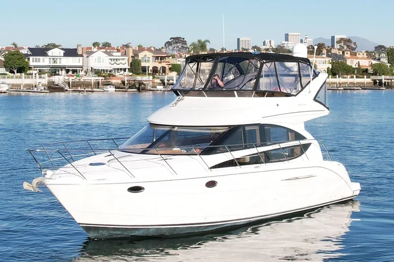 Cynisca Yacht Photos Pics 2006 Meridian 391 Sedan yacht cruising in a scenic waterfront area.