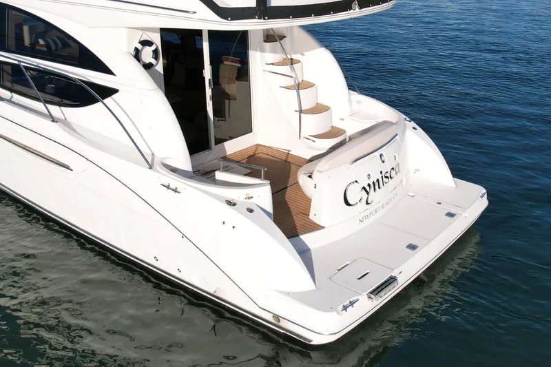 Cynisca Yacht Photos Pics 2006 Meridian 391 Sedan yacht on water, rear view with stairs and deck.