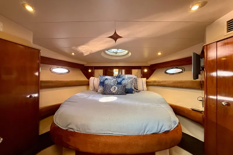 Cynisca Yacht Photos Pics Luxurious 2006 Meridian 391 Sedan yacht bedroom with elegant wood finishes and cozy bedding.