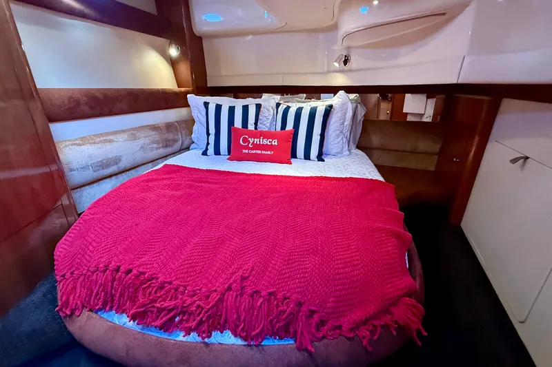 Cynisca Yacht Photos Pics Luxurious cabin interior of 2006 Meridian 391 Sedan with cozy bed and vibrant decor.