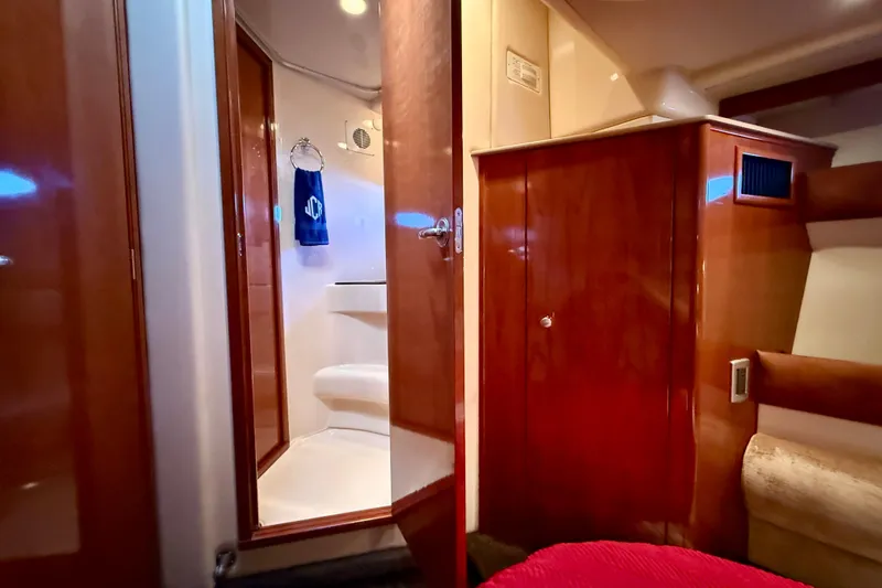 Cynisca Yacht Photos Pics Luxurious interior of 2006 Meridian 391 Sedan yacht with wooden cabinetry and bathroom view.