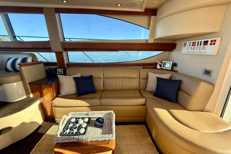 Cynisca Yacht Photos Pics Luxurious interior of a 2006 Meridian 391 Sedan yacht with beige leather seating.