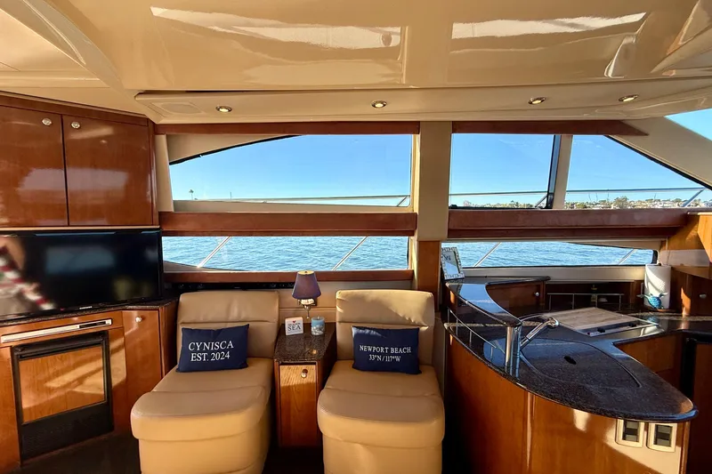 Cynisca Yacht Photos Pics Luxurious interior of 2006 Meridian 391 Sedan yacht with ocean view and elegant furnishings.