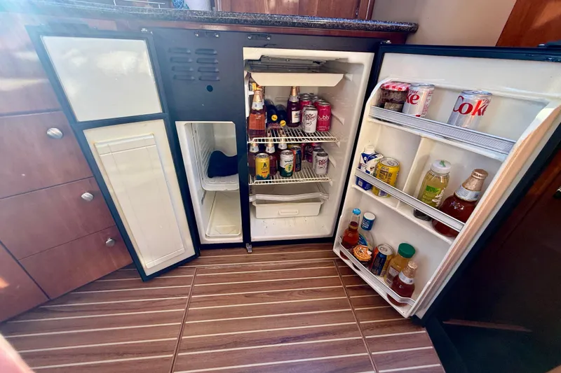 Cynisca Yacht Photos Pics Open fridge in 2006 Meridian 391 Sedan yacht, stocked with beverages and snacks.