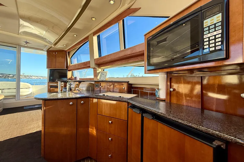 Cynisca Yacht Photos Pics Luxurious interior of 2006 Meridian 391 Sedan yacht with modern kitchen amenities.
