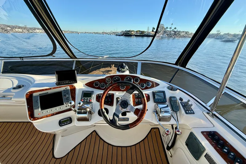Cynisca Yacht Photos Pics 2006 Meridian 391 Sedan helm with navigation controls and scenic water view.