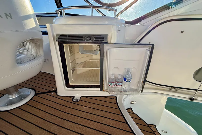 Cynisca Yacht Photos Pics Open mini fridge on 2006 Meridian 391 Sedan boat with water bottles inside.