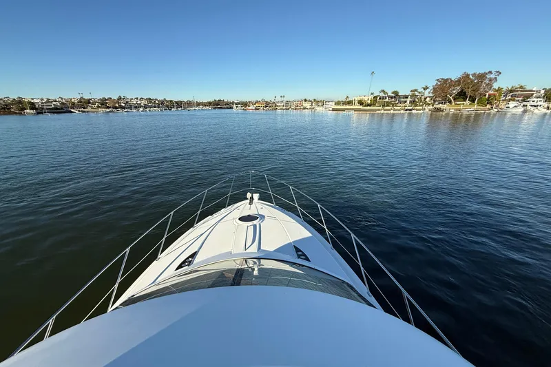 Cynisca Yacht Photos Pics Bow view of 2006 Meridian 391 Sedan yacht cruising in a serene harbor.