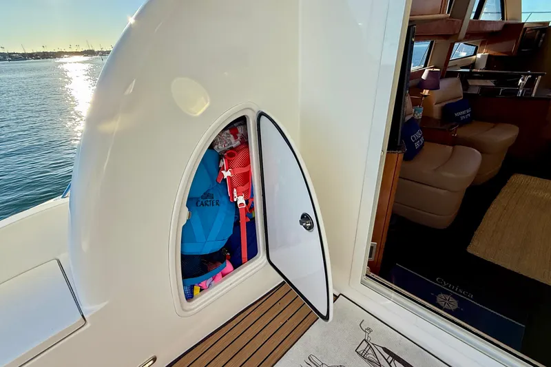 Cynisca Yacht Photos Pics 2006 Meridian 391 Sedan yacht with open storage compartment and interior view.