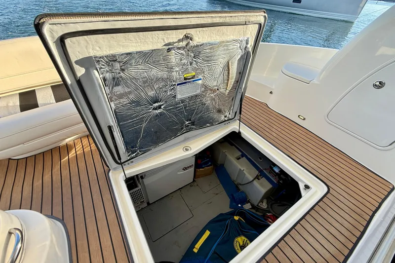 Cynisca Yacht Photos Pics Open hatch on 2006 Meridian 391 Sedan boat, revealing storage compartment.