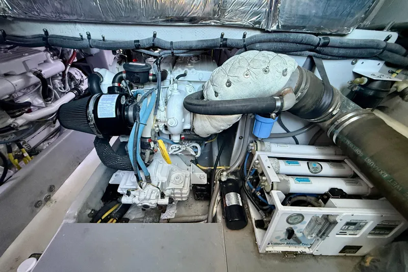 Cynisca Yacht Photos Pics Engine room of a 2006 Meridian 391 Sedan yacht, showcasing mechanical components.