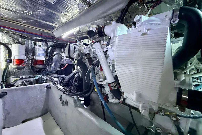 Cynisca Yacht Photos Pics Engine room of a 2006 Meridian 391 Sedan yacht, showcasing mechanical components.