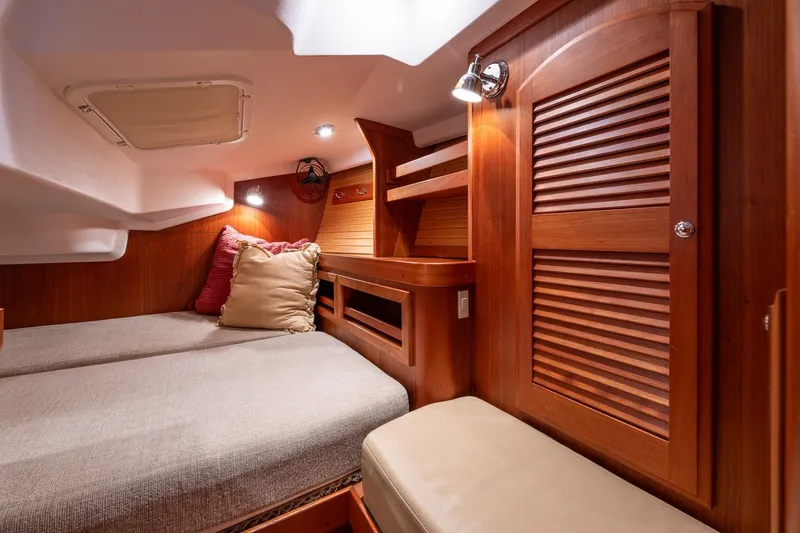 September Song Yacht Photos Pics Luxurious wooden cabin interior of 2007 Sabre 386 yacht with cozy bedding.