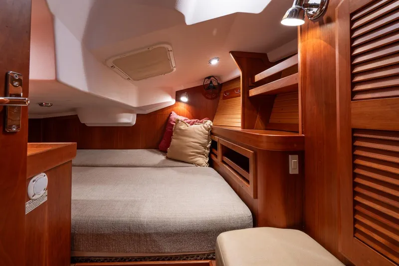 September Song Yacht Photos Pics Cozy cabin interior of 2007 Sabre 386 yacht with wooden finish and comfortable bedding.