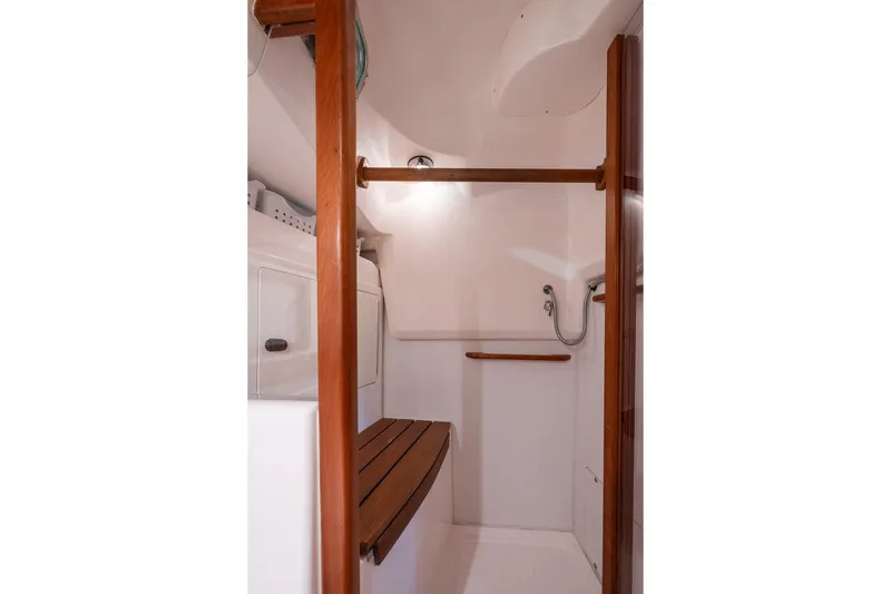September Song Yacht Photos Pics Interior of 2007 Sabre 386 yacht shower with wooden accents and modern fixtures.