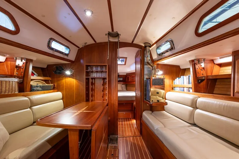 September Song Yacht Photos Pics Luxurious interior of 2007 Sabre 386 yacht with wood finish and comfortable seating.