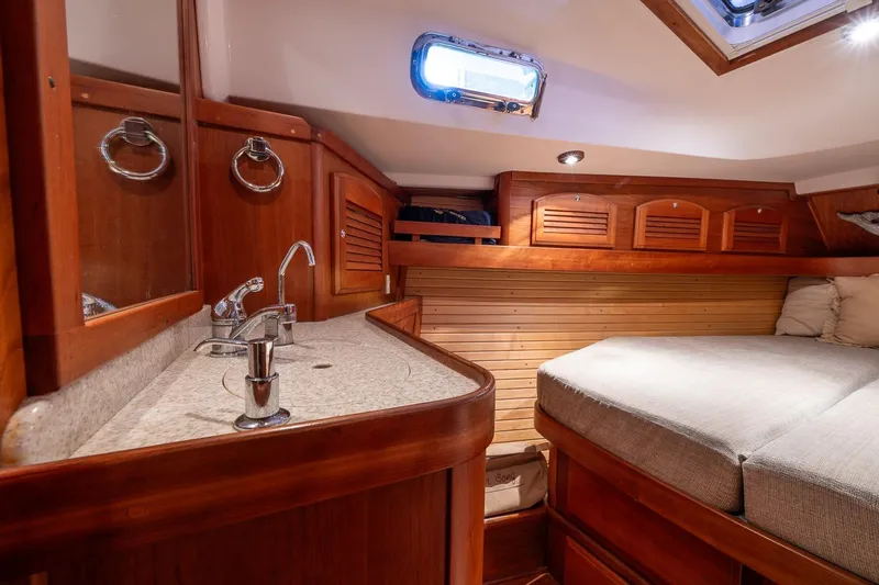 September Song Yacht Photos Pics Luxurious 2007 Sabre 386 yacht cabin with wooden interior and cozy bed.