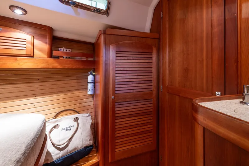 September Song Yacht Photos Pics Interior of 2007 Sabre 386 yacht with wooden cabinetry and cozy sleeping area.