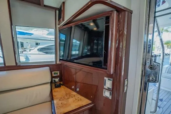 My Reality Yacht Photos Pics Luxurious interior of 2012 Neptunus 62 Flybridge yacht with TV and seating area.