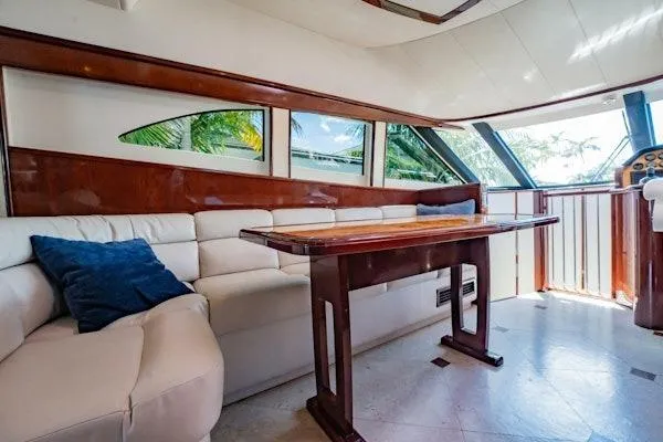 My Reality Yacht Photos Pics Luxurious interior of 2012 Neptunus 62 Flybridge yacht with elegant seating and table.