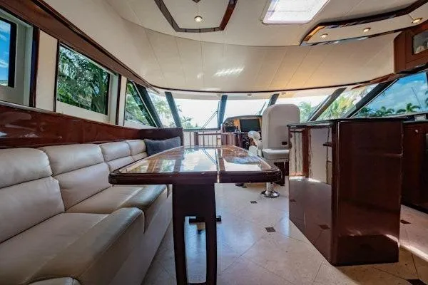 My Reality Yacht Photos Pics Luxurious interior of 2012 Neptunus 62 Flybridge yacht with elegant seating and panoramic windows.