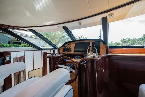 My Reality Yacht Photos Pics Luxurious helm of 2012 Neptunus 62 Flybridge yacht with modern controls and panoramic windows.