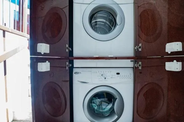 My Reality Yacht Photos Pics Stacked washing machines in a wooden cabinet on a Neptunus 62 Flybridge yacht.