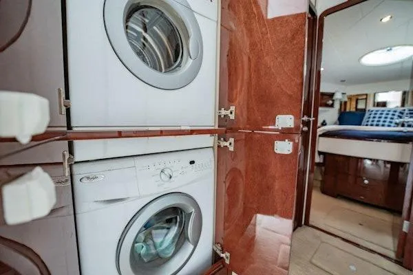 My Reality Yacht Photos Pics Laundry area inside 2012 Neptunus 62 Flybridge yacht with washer and dryer.