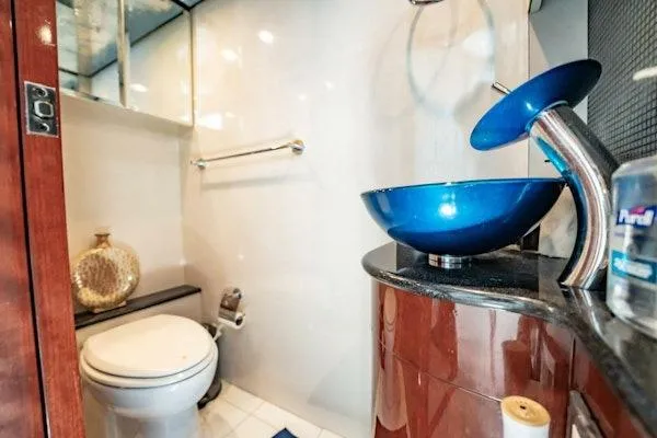 My Reality Yacht Photos Pics Luxurious bathroom in 2012 Neptunus 62 Flybridge yacht with modern blue glass sink.