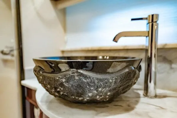 My Reality Yacht Photos Pics Stone vessel sink and modern faucet in 2012 Neptunus 62 Flybridge yacht bathroom.