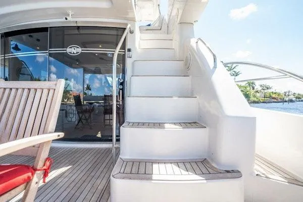 My Reality Yacht Photos Pics 2012 Neptunus 62 Flybridge yacht with elegant outdoor staircase and seating area.