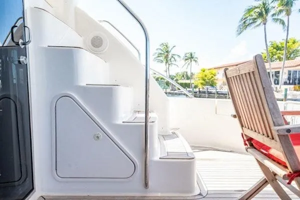 My Reality Yacht Photos Pics 2012 Neptunus 62 Flybridge yacht deck with stairs and wooden chair.