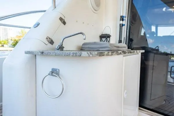 My Reality Yacht Photos Pics Luxurious 2012 Neptunus 62 Flybridge yacht with sleek outdoor sink and countertop.