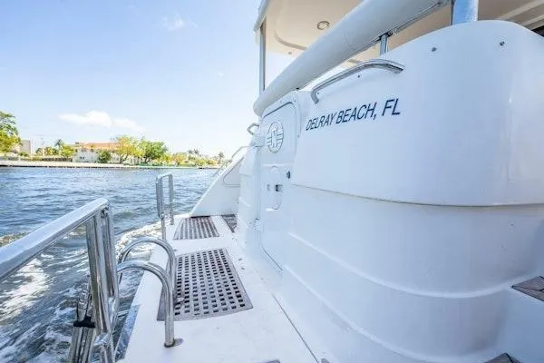 My Reality Yacht Photos Pics 2012 Neptunus 62 Flybridge yacht docked, Delray Beach, FL, sunny day, waterfront view.