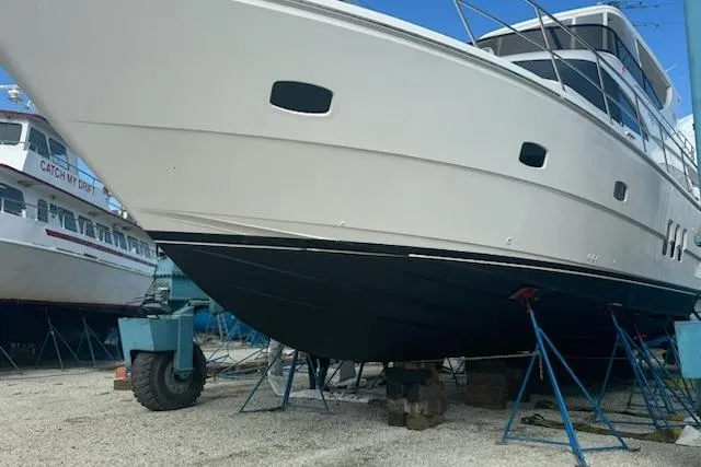 My Reality Yacht Photos Pics 2012 Neptunus 62 Flybridge yacht on dry dock, supported by stands.
