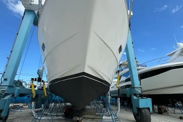 My Reality Yacht Photos Pics 2012 Neptunus 62 Flybridge yacht in dry dock, viewed from the front.