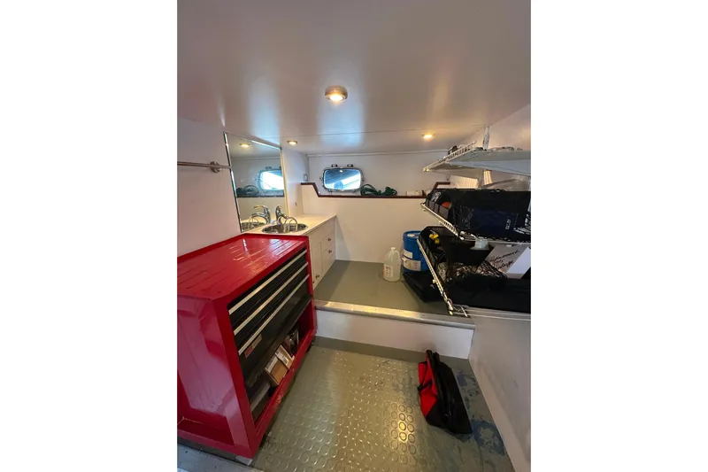 My Reality Yacht Photos Pics Interior of 2012 Neptunus 62 Flybridge yacht with red tool chest and storage shelves.