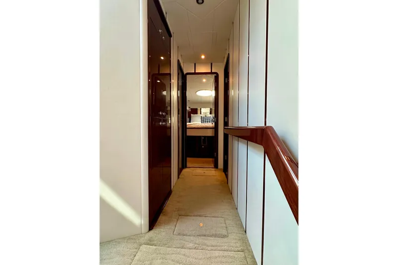 My Reality Yacht Photos Pics Hallway inside 2012 Neptunus 62 Flybridge yacht, featuring elegant wood finishes and plush carpeting.