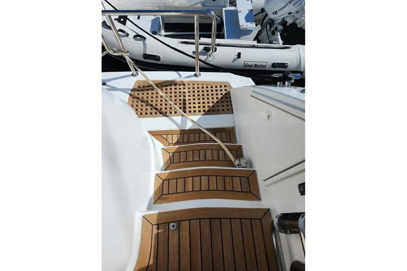 My Reality Yacht Photos Pics Staircase on 2012 Neptunus 62 Flybridge yacht with wooden steps and railing.